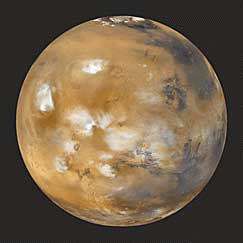 Foto di Marte, in cui sono visibili delle nubi sui rilievi più alti.